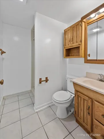 a bathroom with a sink toilet and mirror