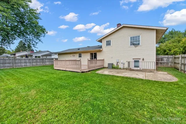 a view of a house with a yard and sitting area