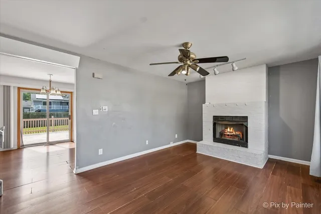 a view of a livingroom with a fireplace and wooden floor