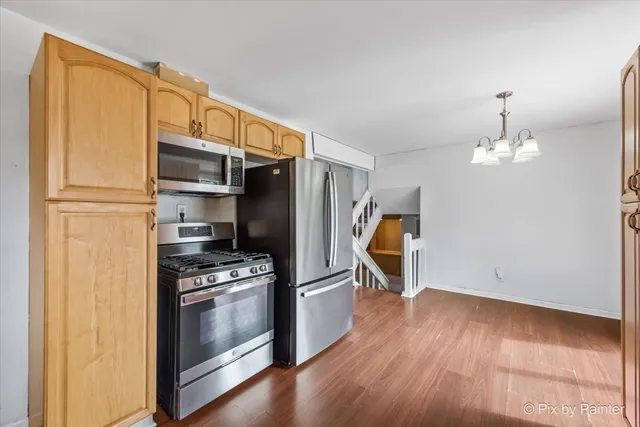 a kitchen with stainless steel appliances a refrigerator and a stove top oven
