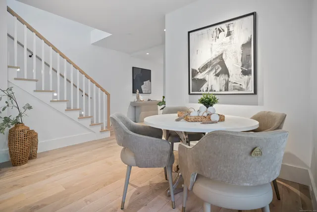 a view of a dining room with furniture wooden floor and a chandelier
