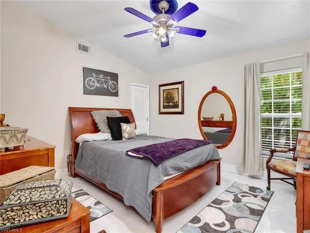 a bed room with a bed and a painting on the wall