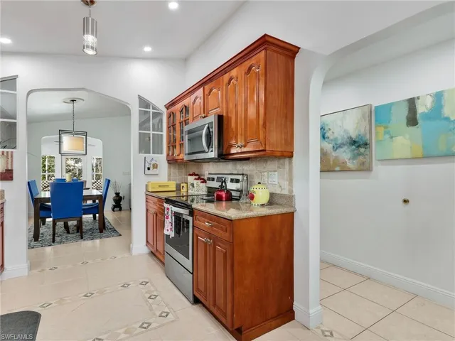 a kitchen with stainless steel appliances granite countertop a refrigerator a stove top oven a sink and dishwasher