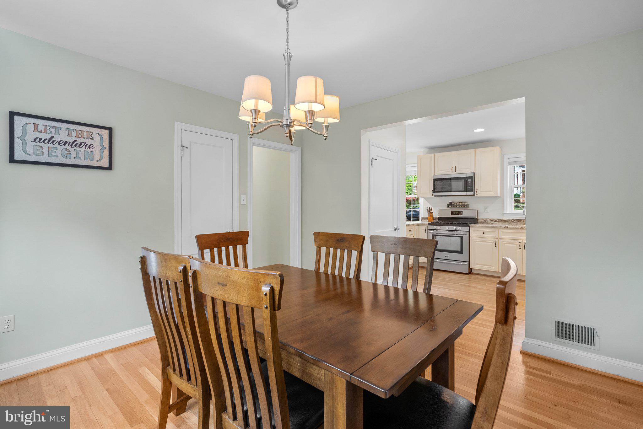 10406 Brookmoor Drive Silver Spring, MD 20901 - Photo 13 of 45 a view of a dining room with furniture wooden floor and chandelier