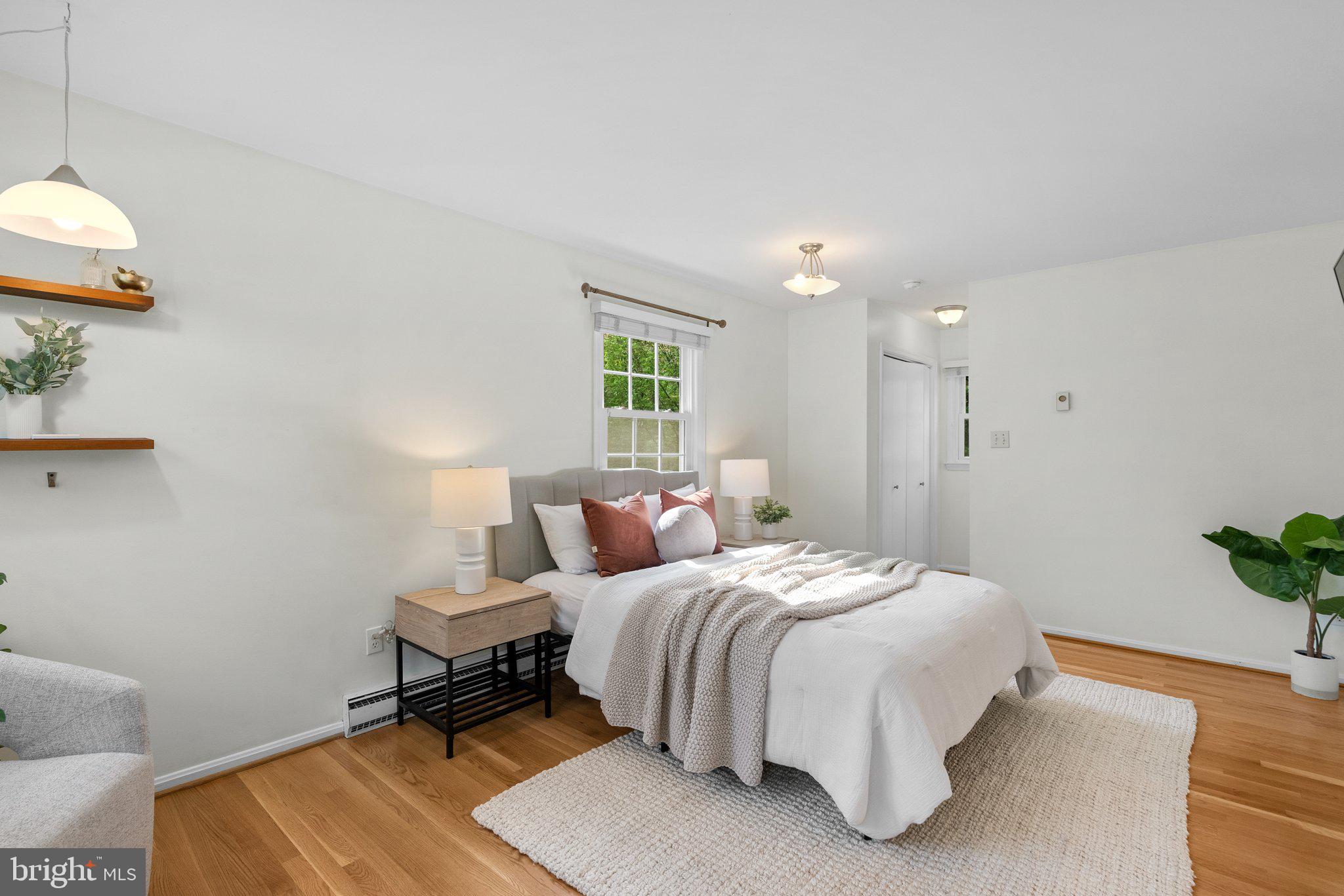 10406 Brookmoor Drive Silver Spring, MD 20901 - Photo 14 of 45 a bedroom with a bed and a potted plant