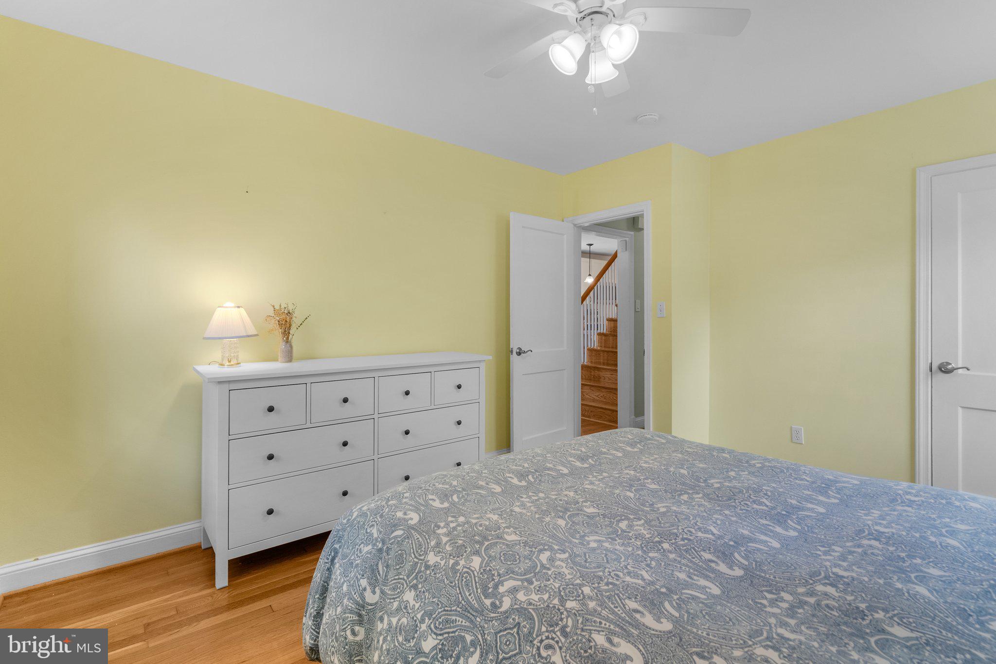 10406 Brookmoor Drive Silver Spring, MD 20901 - Photo 18 of 45 a spacious bedroom with a bed and a chandelier