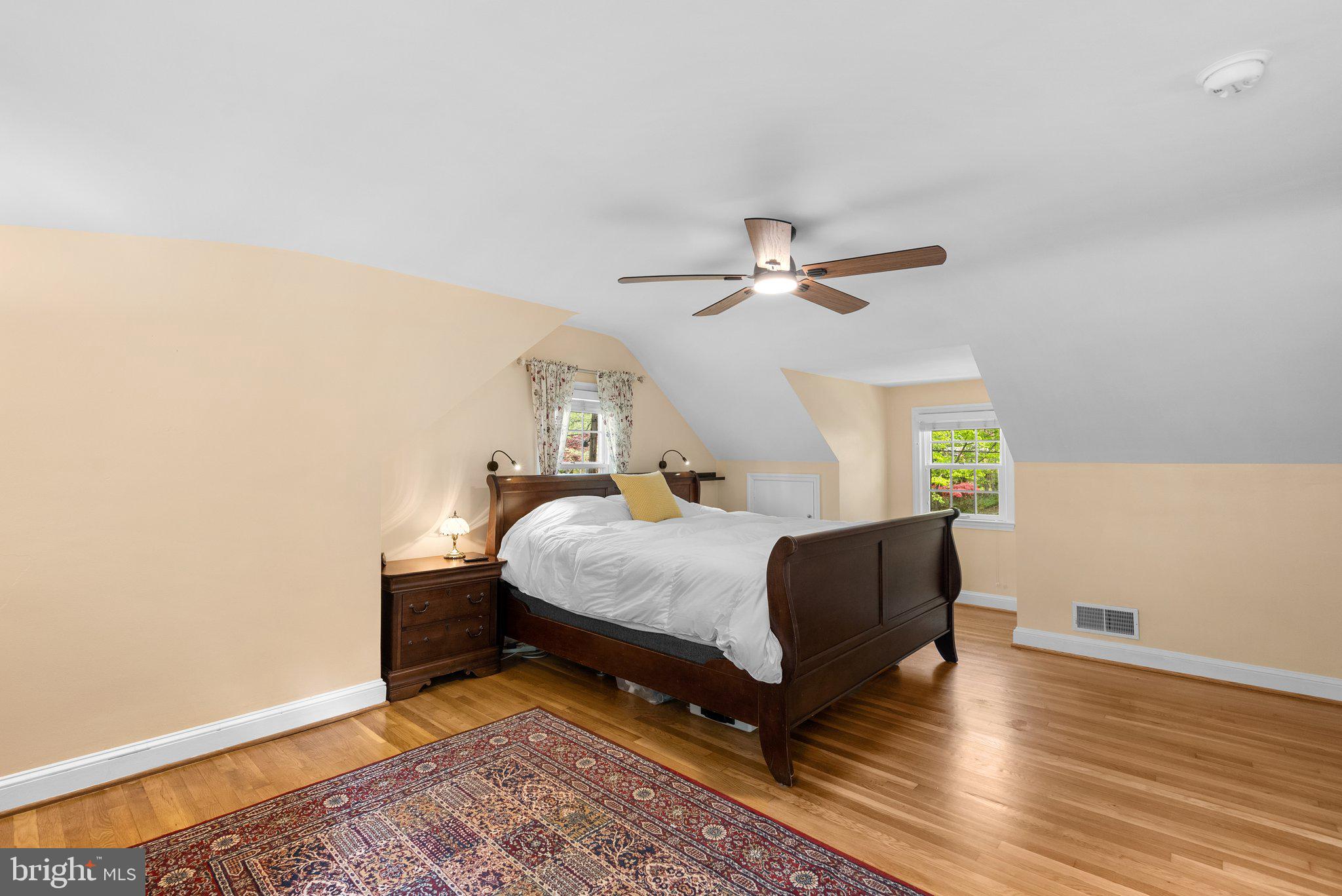 10406 Brookmoor Drive Silver Spring, MD 20901 - Photo 20 of 45 a bedroom with a bed lamps and wooden floor