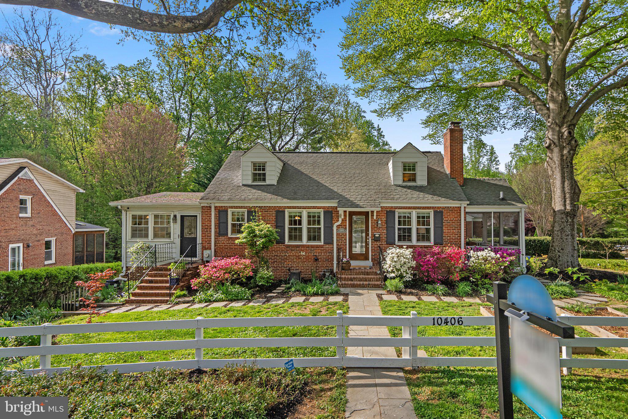 10406 Brookmoor Drive Silver Spring, MD 20901 - Photo 2 of 45 a front view of a house with a yard and potted plants