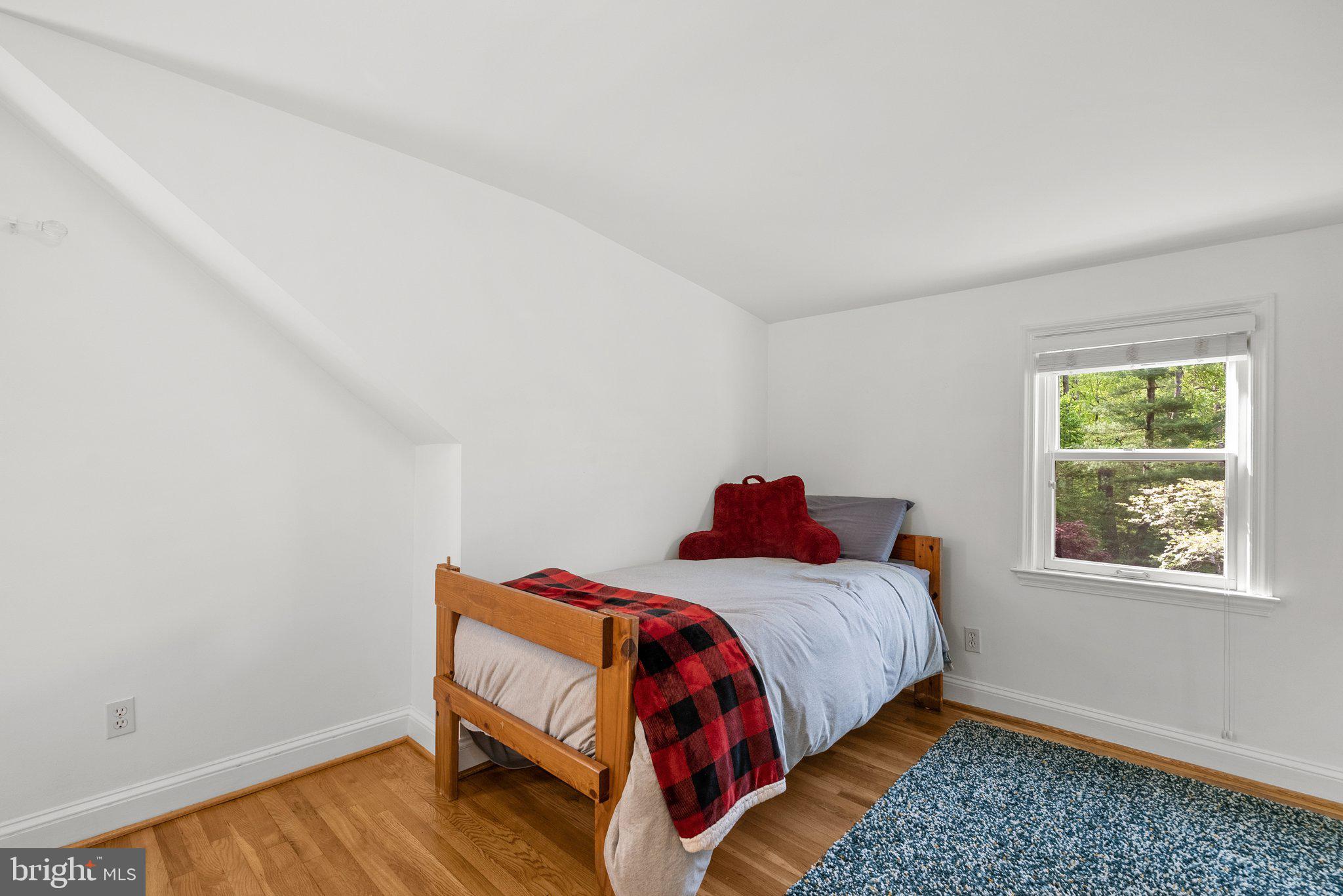 10406 Brookmoor Drive Silver Spring, MD 20901 - Photo 23 of 45 a bed sitting in a bedroom next to a window