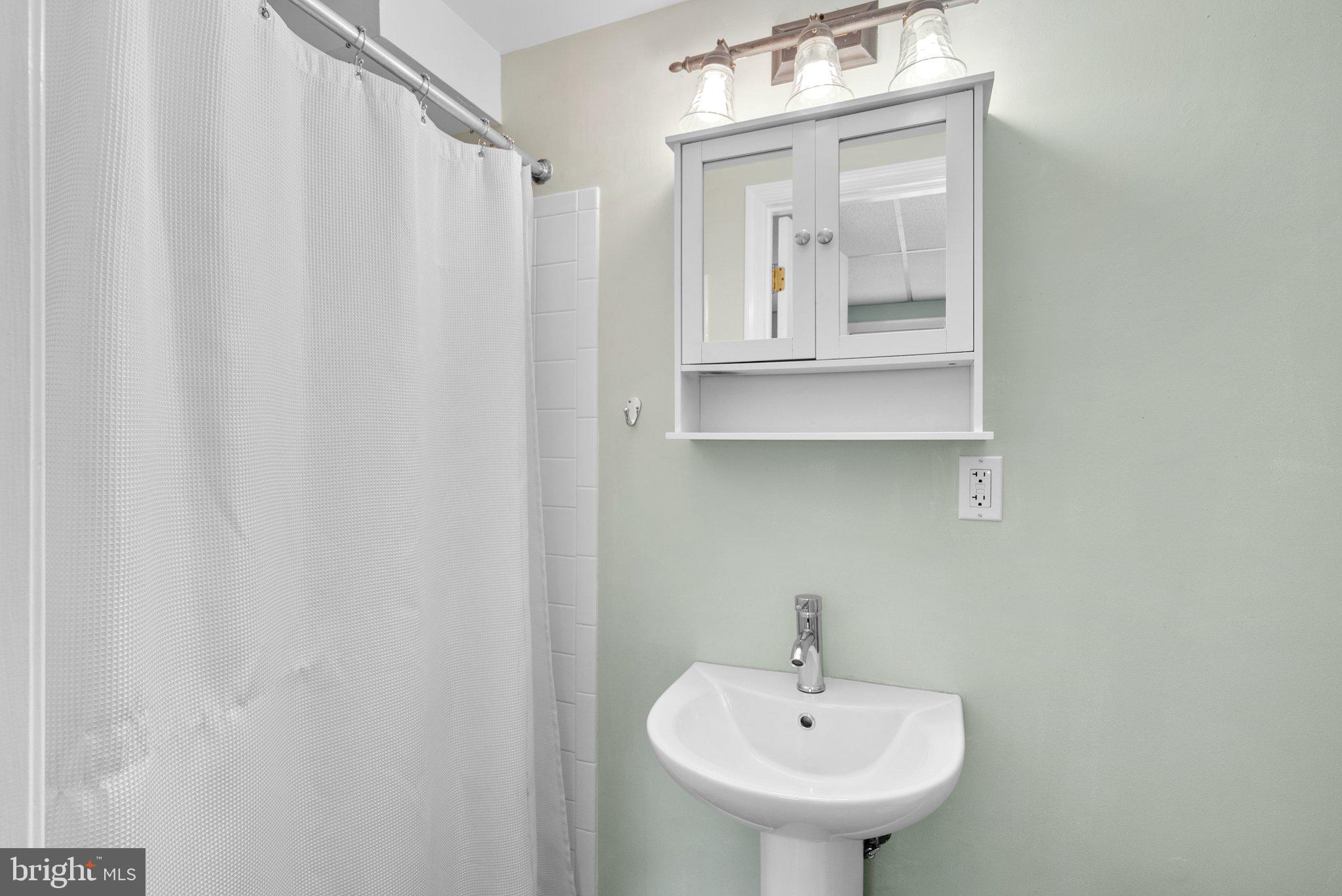 10406 Brookmoor Drive Silver Spring, MD 20901 - Photo 30 of 45 a bathroom with a sink and a mirror