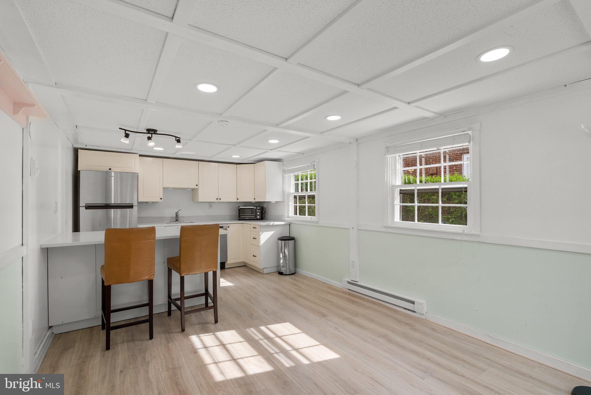 10406 Brookmoor Drive Silver Spring, MD 20901 - Photo 31 of 45 a kitchen with a table chairs refrigerator and cabinets