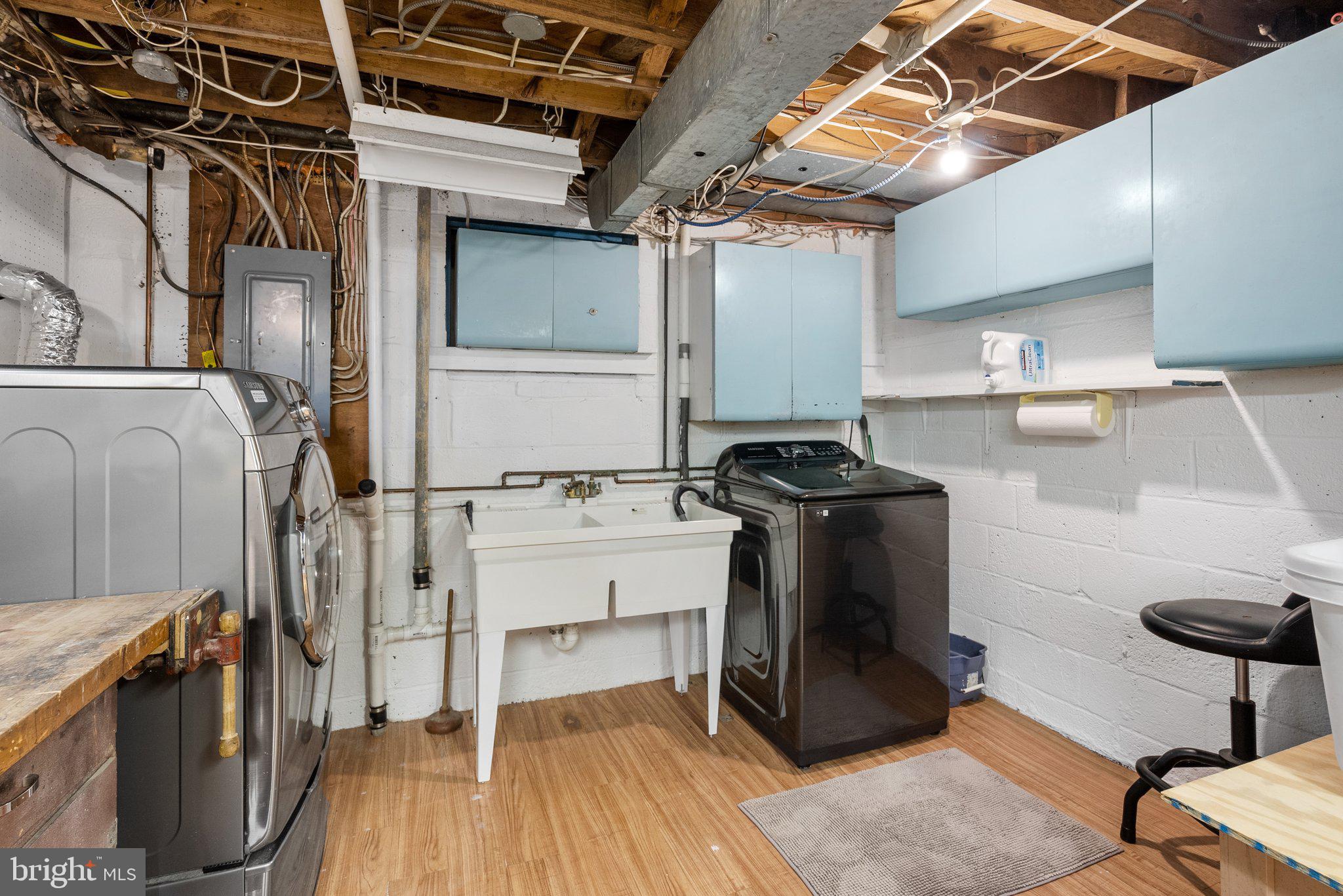 10406 Brookmoor Drive Silver Spring, MD 20901 - Photo 36 of 45 a view of a kitchen with kitchen island a stove a wooden floor and a sink