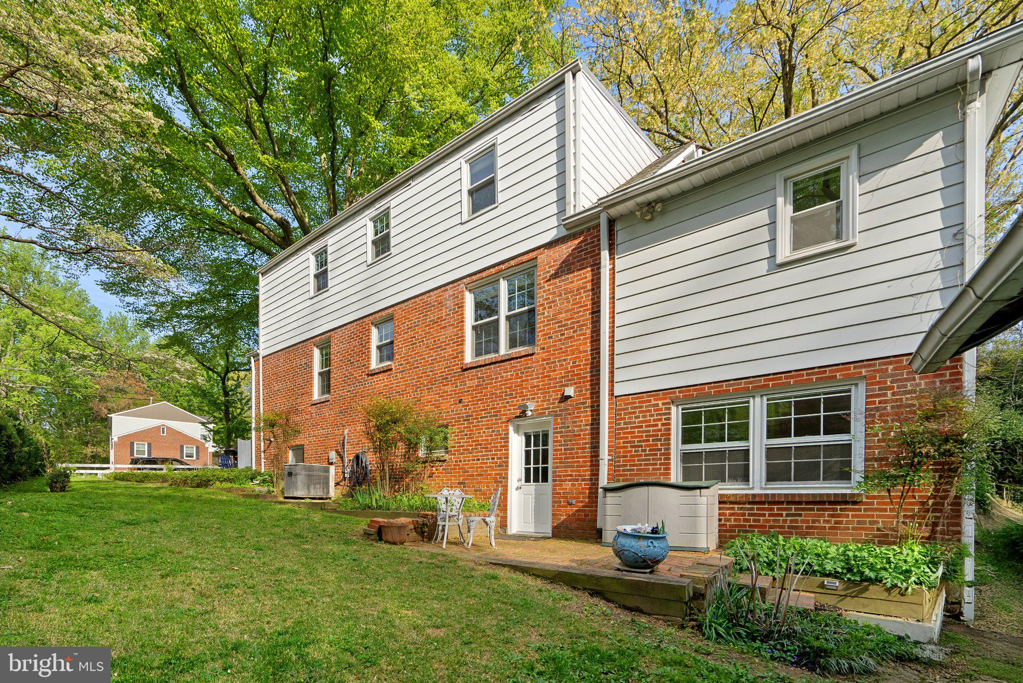 10406 Brookmoor Drive Silver Spring, MD 20901 - Photo 44 of 45 a front view of a house with a yard and potted plants