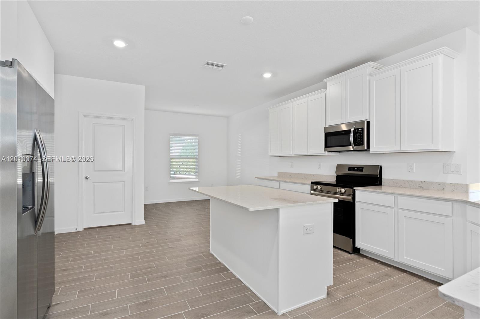 7789 Southwest 196th Terrace, Unit 1 Dunnellon, FL 34432 - Photo 15 of 36 a kitchen with stainless steel appliances a stove refrigerator sink and cabinets