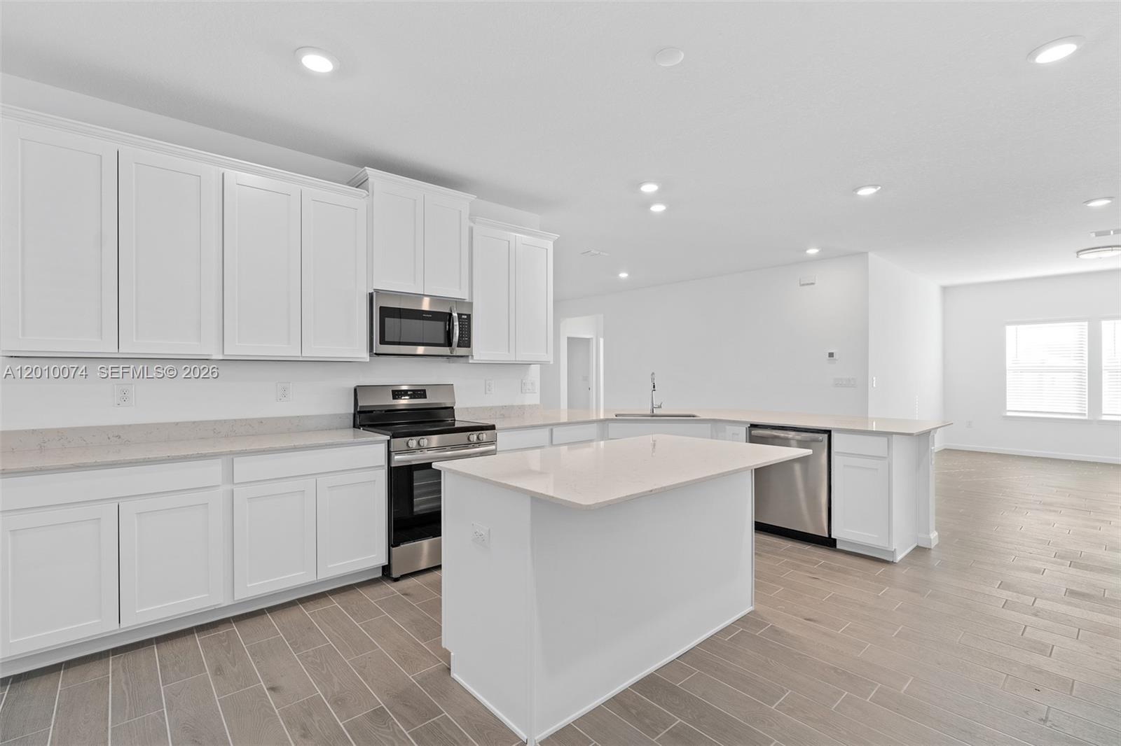 7789 Southwest 196th Terrace, Unit 1 Dunnellon, FL 34432 - Photo 16 of 36 a kitchen with a sink a stove top oven and white stainless steel appliances