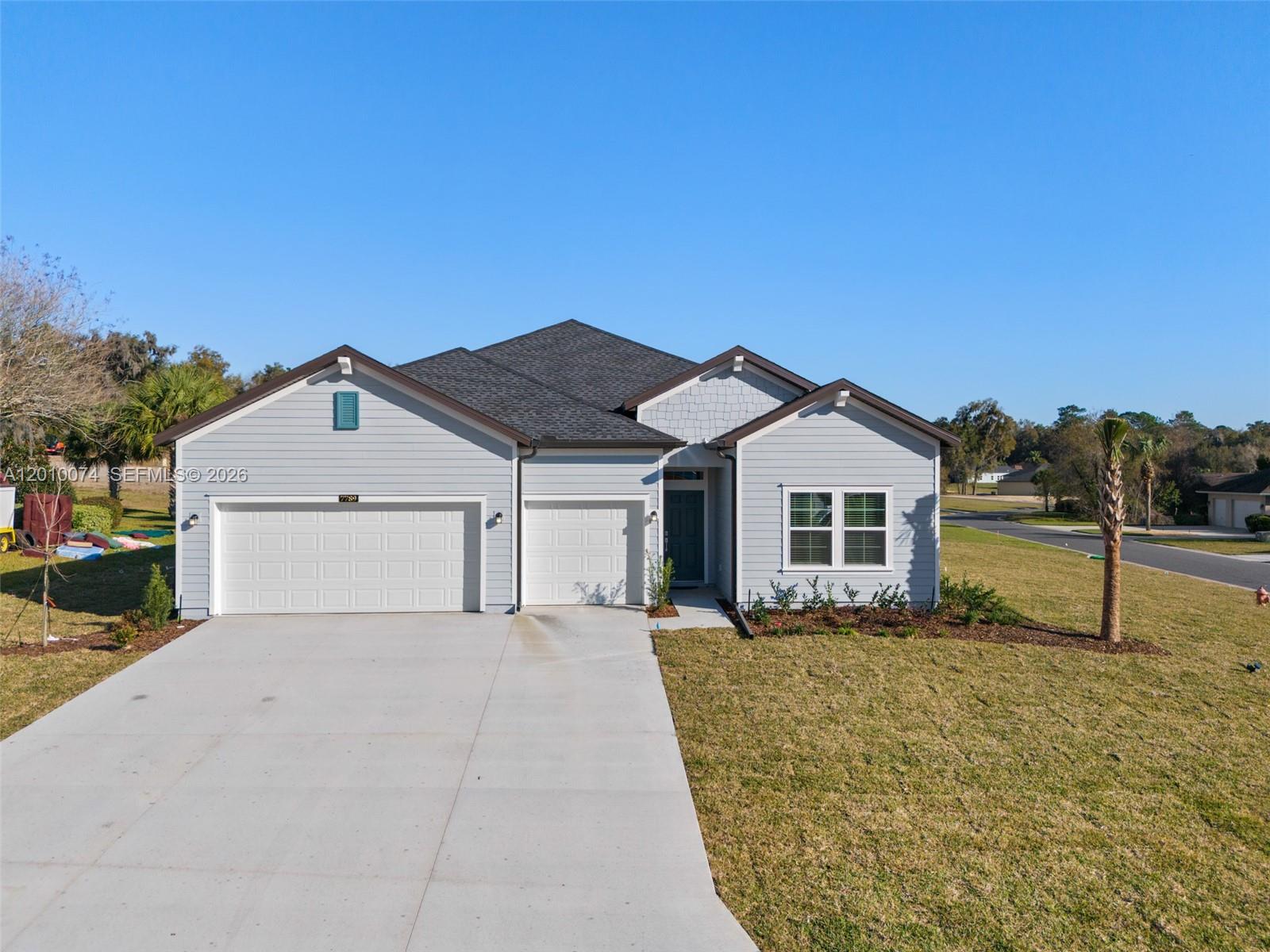 7789 Southwest 196th Terrace, Unit 1 Dunnellon, FL 34432 - Photo 2 of 36 a front view of a house with a yard and garage