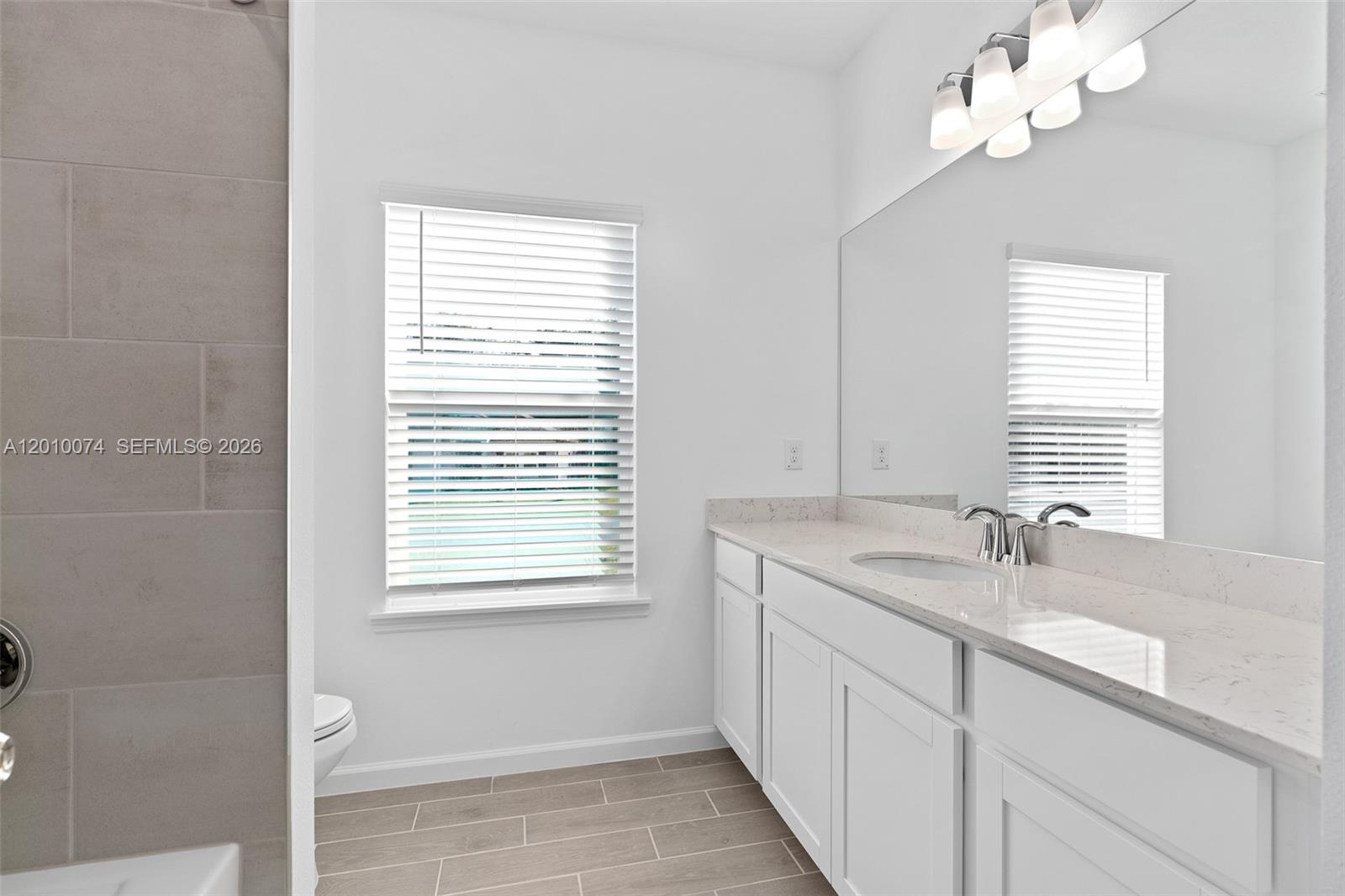 7789 Southwest 196th Terrace, Unit 1 Dunnellon, FL 34432 - Photo 23 of 36 a bathroom with a sink a vanity and a window
