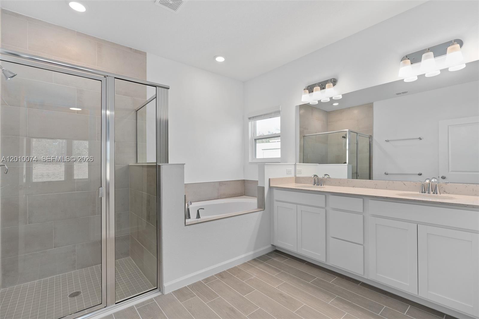 7789 Southwest 196th Terrace, Unit 1 Dunnellon, FL 34432 - Photo 31 of 36 a bathroom with a double vanity sink mirror and shower