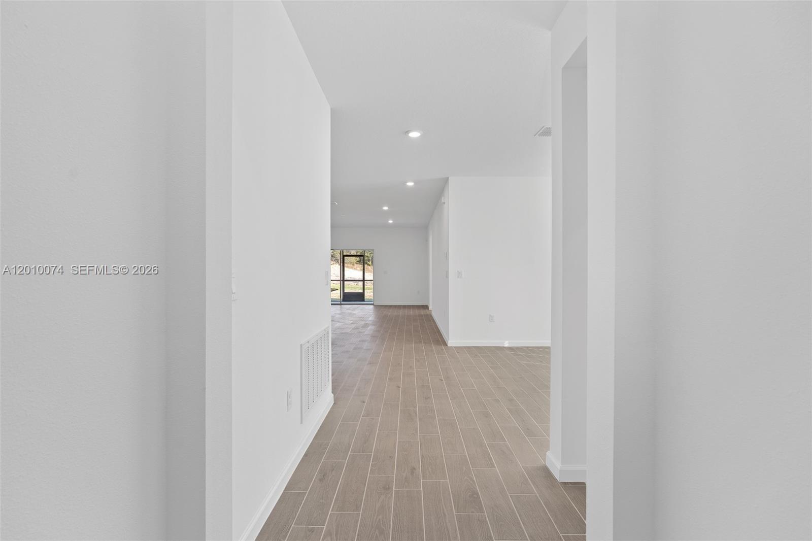 7789 Southwest 196th Terrace, Unit 1 Dunnellon, FL 34432 - Photo 5 of 36 a view of a hallway with wooden floor