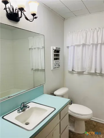 a bathroom with a sink a toilet and mirror