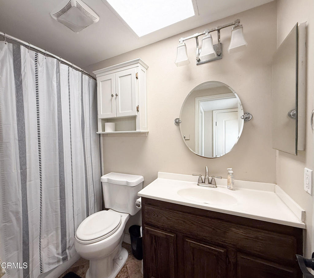 3000 Isle Way, Unit C Oxnard, CA 93035 - Photo 14 of 22 a bathroom with a toilet a sink and a mirror