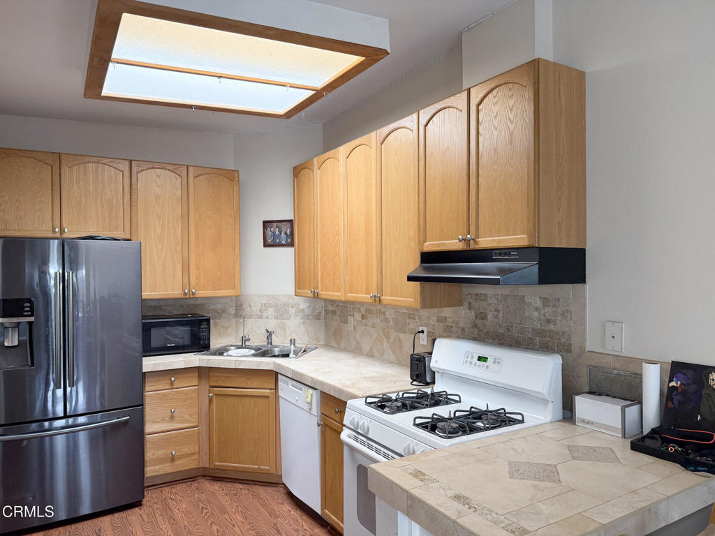 3000 Isle Way, Unit C Oxnard, CA 93035 - Photo 3 of 22 a kitchen with stainless steel appliances granite countertop a stove a sink dishwasher and a refrigerator