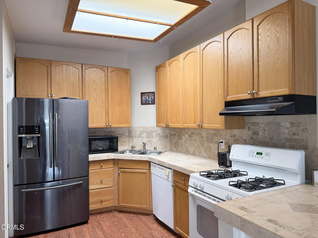3000 Isle Way, Unit C Oxnard, CA 93035 - Photo 4 of 22 a kitchen with stainless steel appliances granite countertop a refrigerator stove and sink