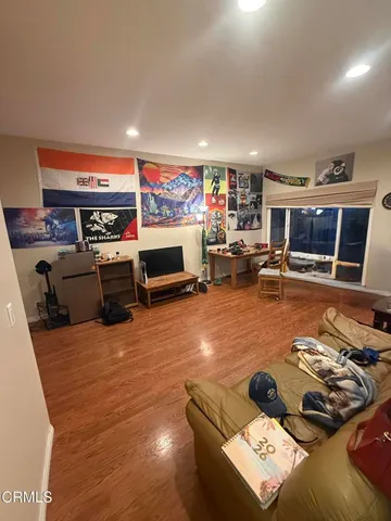 a view of a kitchen with a sink dishwasher a fireplace with wooden floor