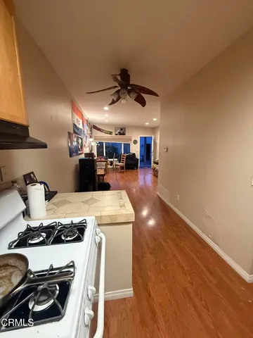 a kitchen with a stove a refrigerator and a sink