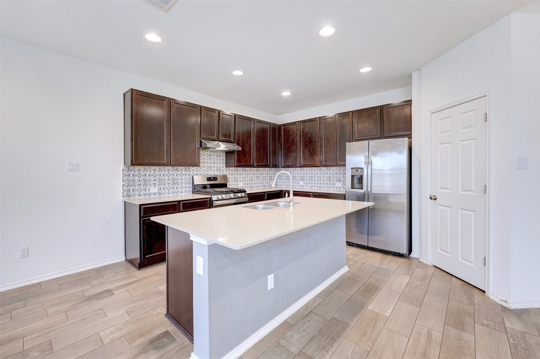 307 Simmental Loop Hutto, TX 78634 - Photo 11 of 34 A contemporary kitchen design featuring a large island and ample cabinet storage.