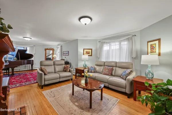 a view of a dining room with furniture and wooden floor