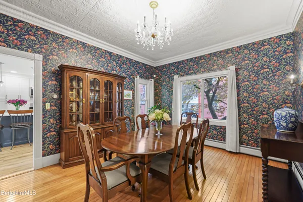 a view of a dining room with furniture window and wooden floor