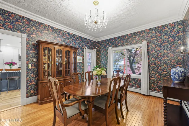 a view of a dining room with furniture window and wooden floor