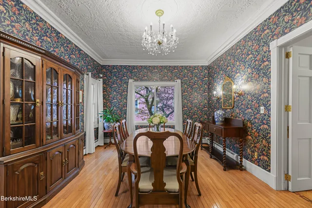 a view of a dining room with furniture wooden floor and chandelier