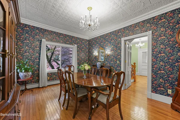 a view of a dining room with furniture and wooden floor