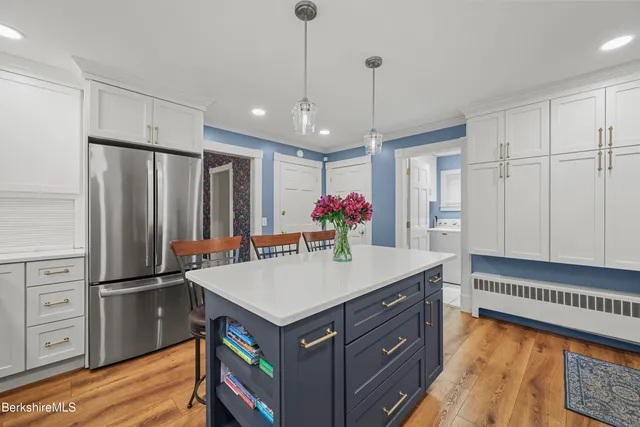 a kitchen with cabinets appliances a sink and a window