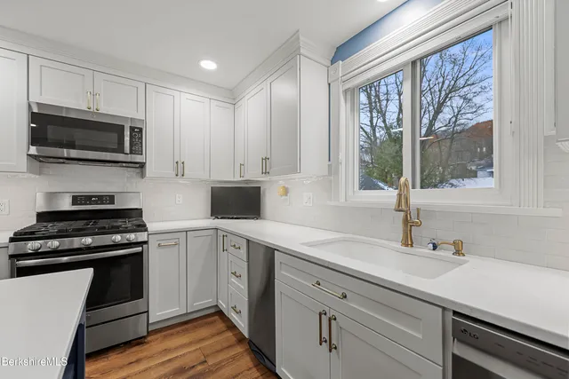 a kitchen that has a table and chairs in it