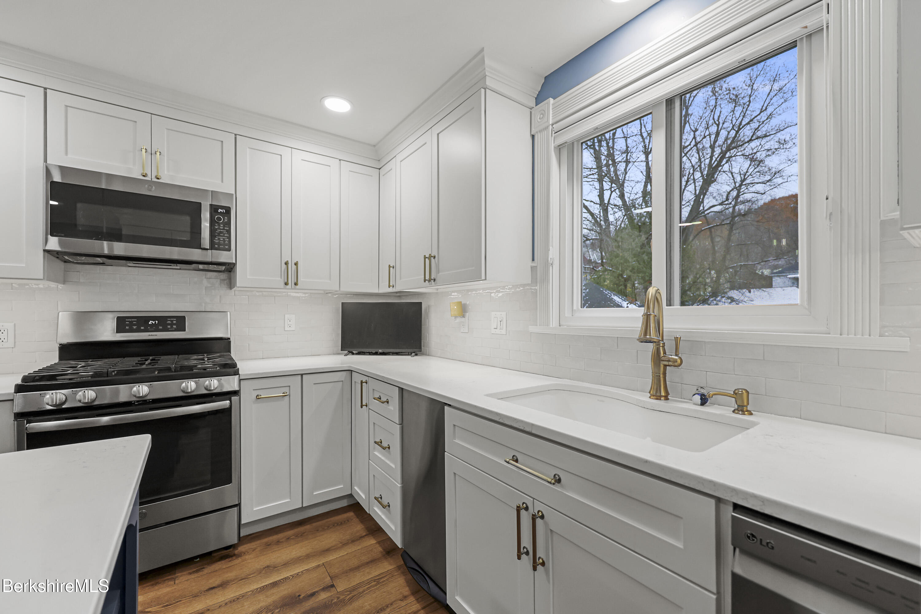 67 Cherry Street North Adams, MA 01247 - Photo 20 of 59 a kitchen with cabinets appliances a sink and a window