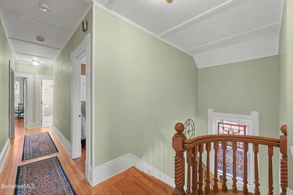 a bedroom with a bed and a lamp on dresser