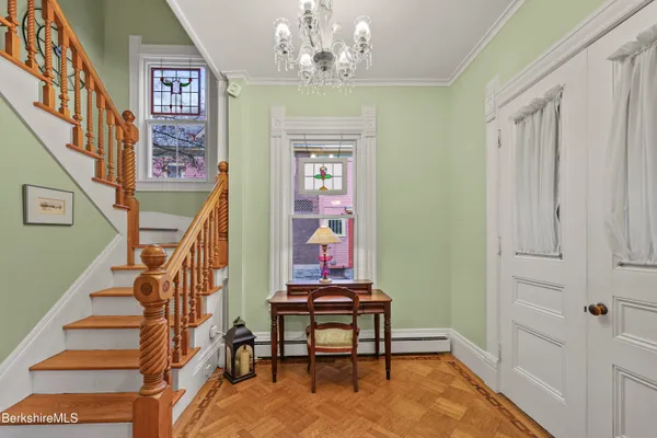 a view of entryway and hall with wooden floor