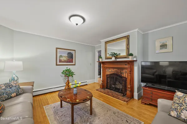 a living room with furniture a flat screen tv and a fireplace