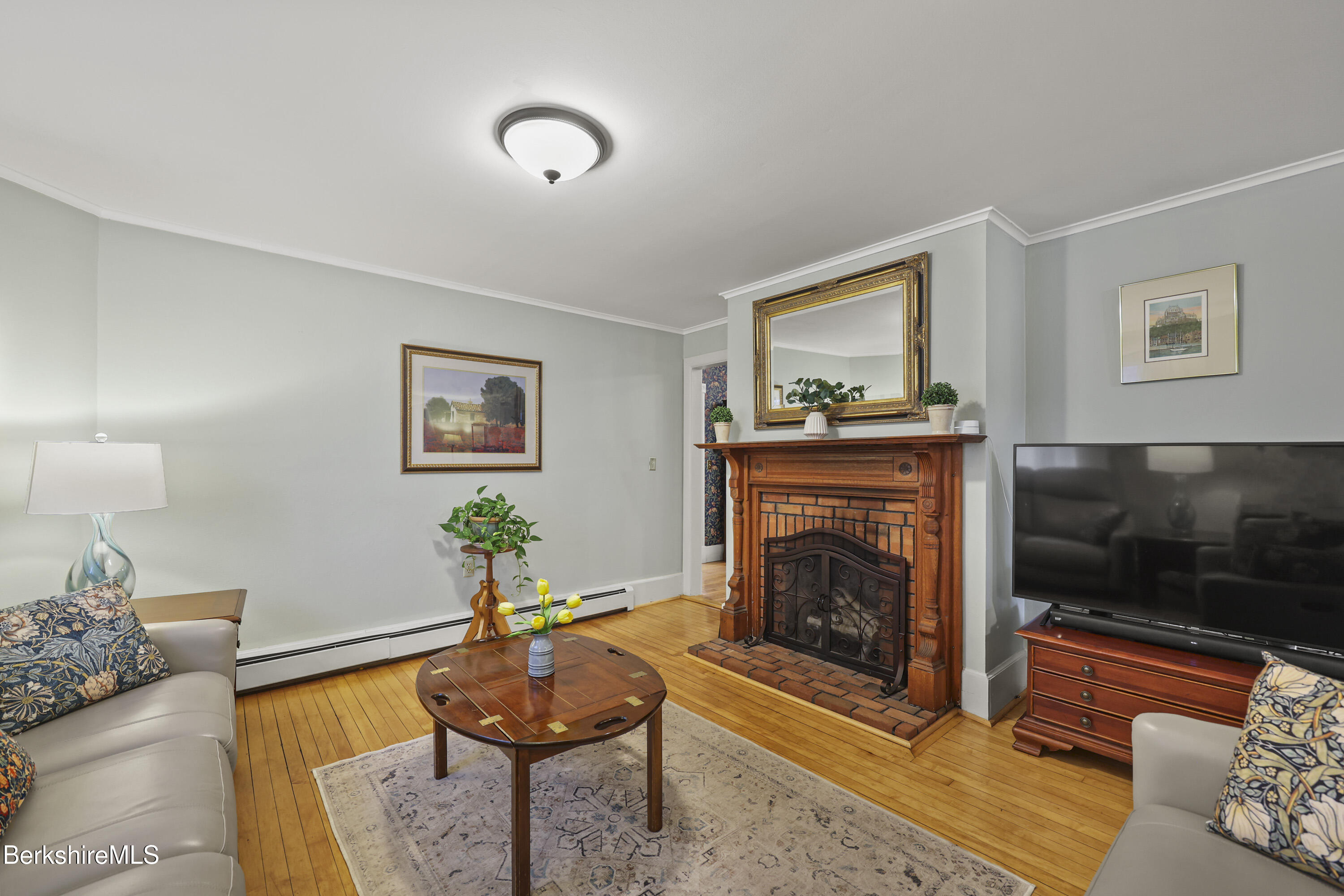 67 Cherry Street North Adams, MA 01247 - Photo 9 of 59 a living room with furniture and a fireplace