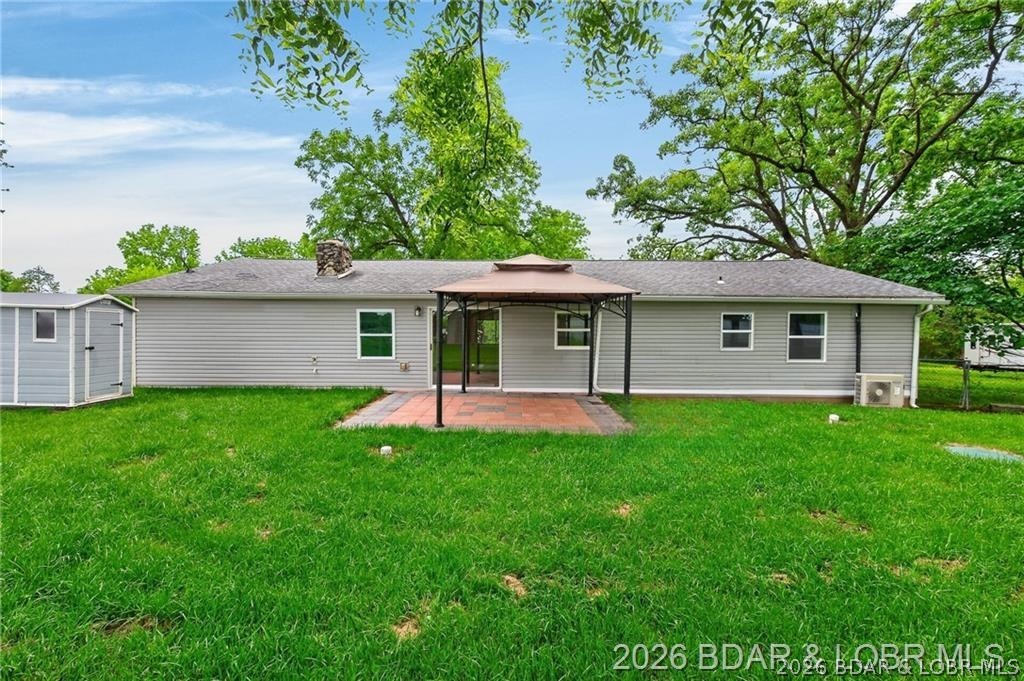 177 Storage Road Eldon, MO 65026 - Photo 27 of 34 The fenced-in backyard features a paved stone pati