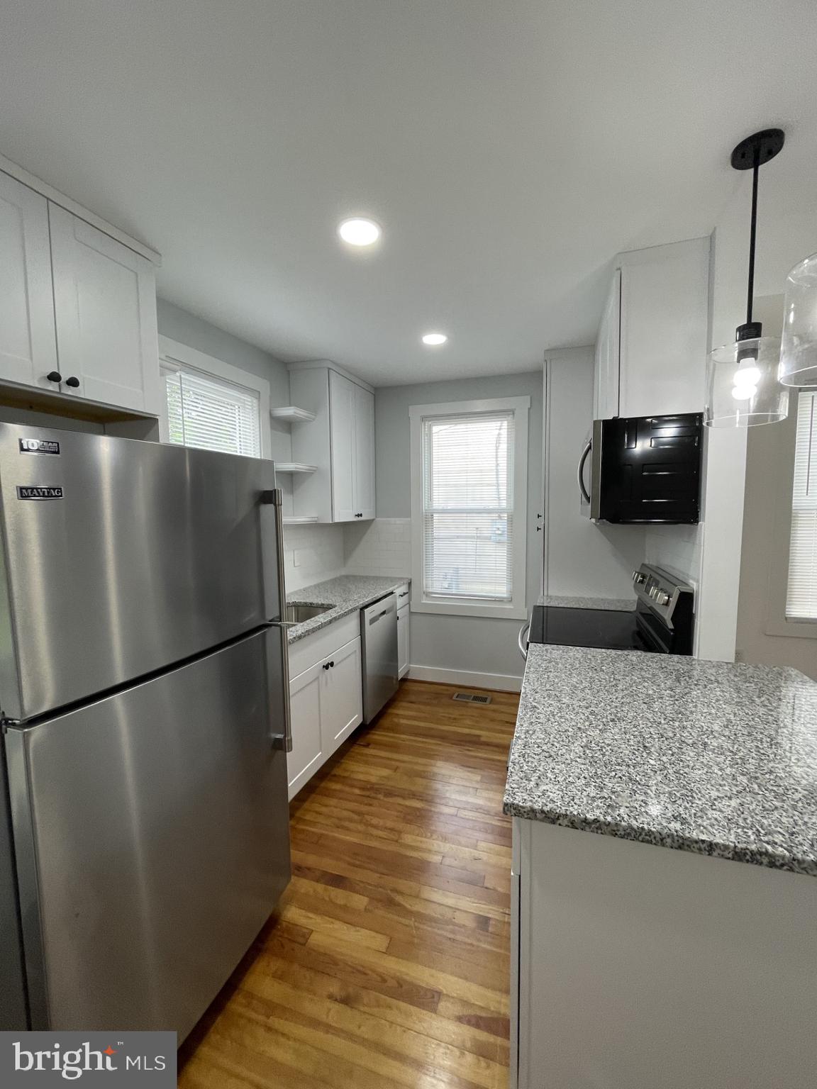 618 Wolfe Street, Unit A Fredericksburg, VA 22401 - Photo 5 of 13 a kitchen with a refrigerator a sink and a stove top oven