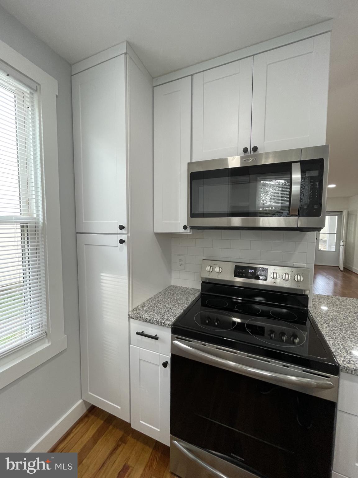618 Wolfe Street, Unit A Fredericksburg, VA 22401 - Photo 7 of 13 a kitchen with stainless steel appliances a stove a microwave and cabinets