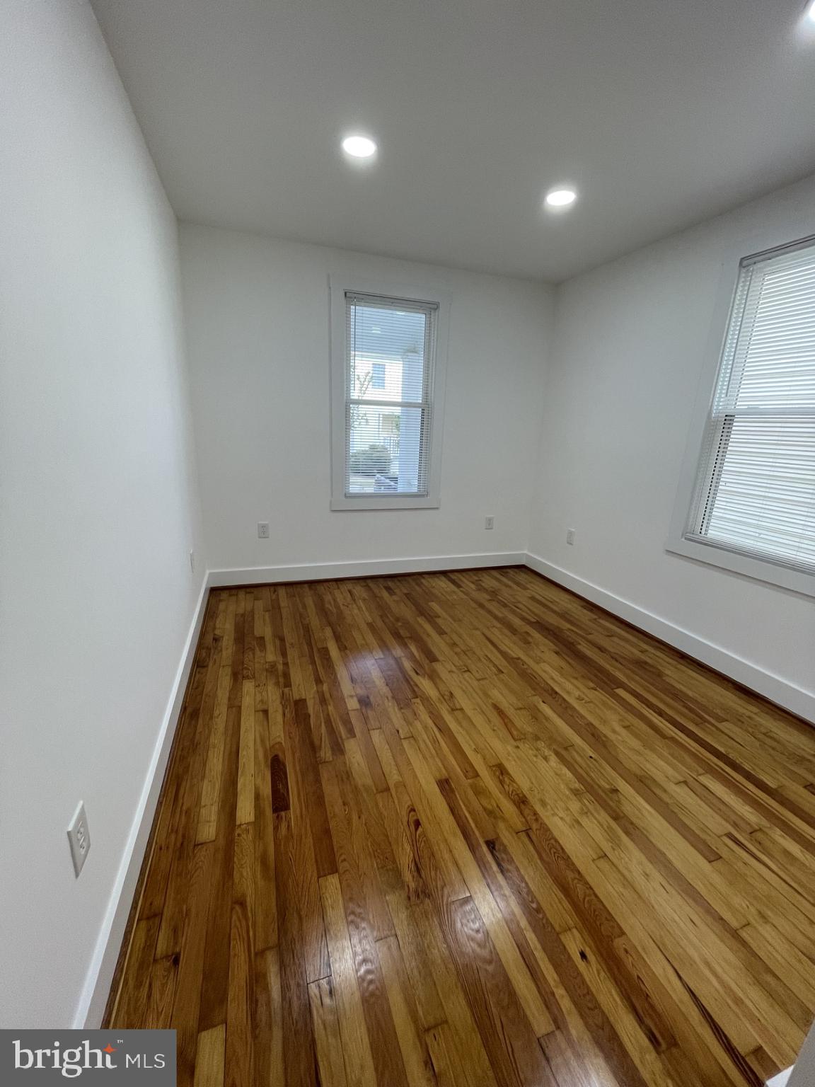 618 Wolfe Street, Unit A Fredericksburg, VA 22401 - Photo 8 of 13 an empty room with wooden floor and windows