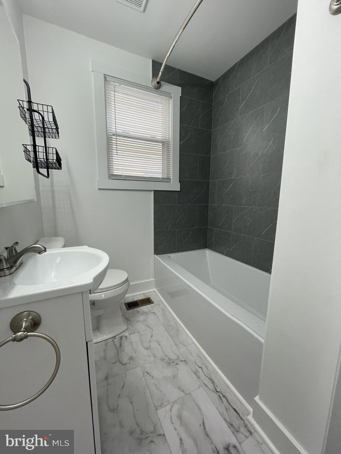 618 Wolfe Street, Unit A Fredericksburg, VA 22401 - Photo 10 of 13 a bathroom with a sink a toilet and shower