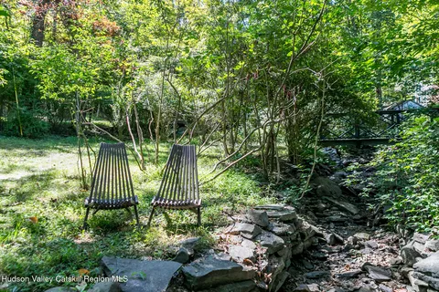 a house that has a tree in front of the house