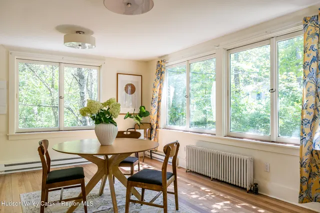 a view of a dining room with furniture and a potted plant