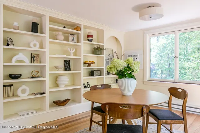 a kitchen with stainless steel appliances a sink a window and cabinets